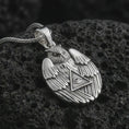 Load image into Gallery viewer, Polished silver owl all-seeing eye pendant necklace on textured volcanic rock, centered macro jewelry photo with detailed owl wings, sacred eye motif, and bright silver highlights.
