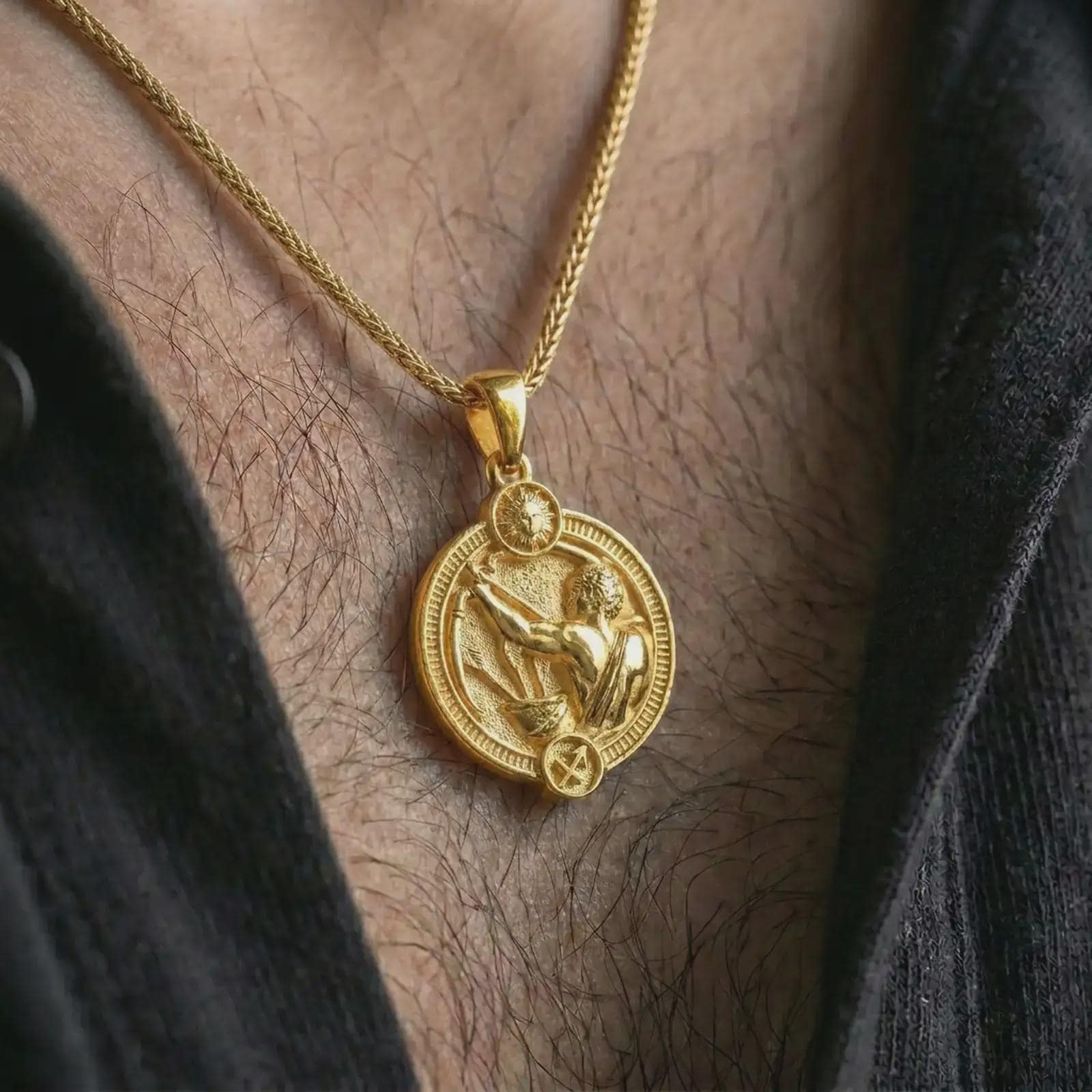 Gold plated Sagittarius zodiac pendant necklace worn on the chest, premium lifestyle jewelry photo with the Sagittarius archer pendant centered on a spiga chain.