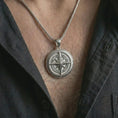 Load image into Gallery viewer, Polished silver compass pendant necklace worn on the chest, masculine lifestyle shot highlighting the bright silver finish, raised compass star, and directional letter details.
