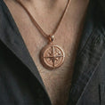 Load image into Gallery viewer, Rose gold plated compass pendant necklace worn on the chest, close-up lifestyle shot featuring the nautical compass design with warm rose gold tones.
