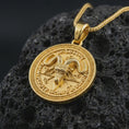 Load image into Gallery viewer, Gold plated Baphomet pendant necklace on textured volcanic rock, premium close-up studio composition emphasizing the Goat of Mendes design, pentagram motif, and dark occult medallion style.
