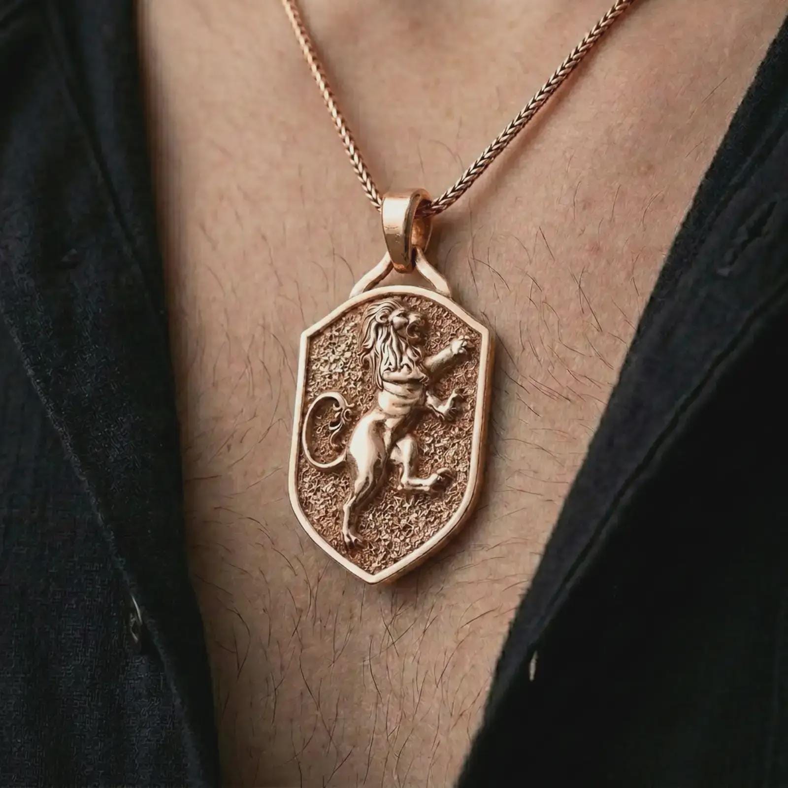 Rose gold plated heraldic lion shield pendant necklace worn on the chest, close-up lifestyle shot featuring the noble heraldic lion design with warm rose gold tones.