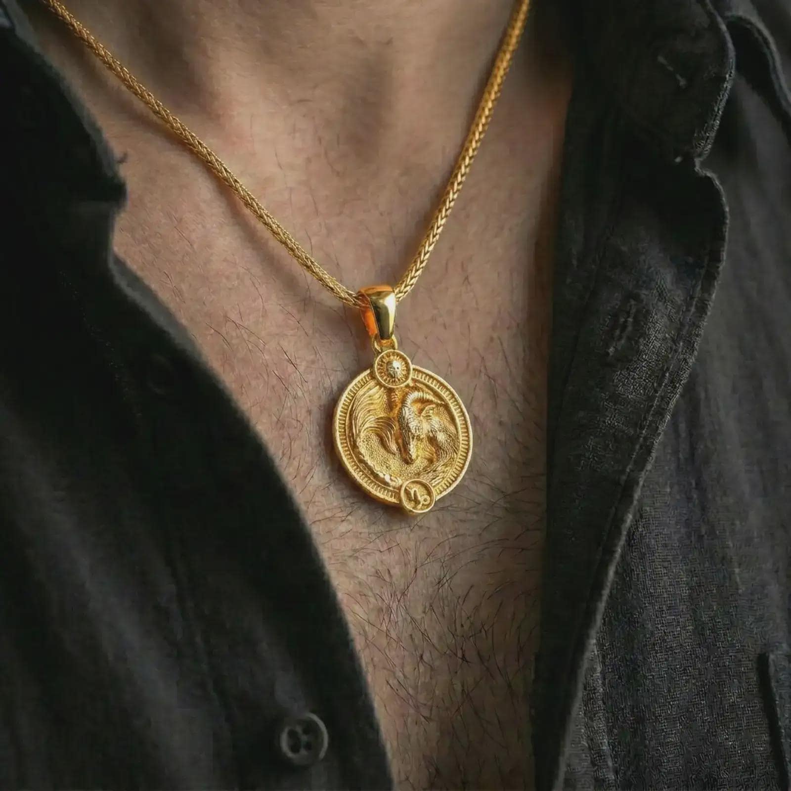 Gold plated Capricorn zodiac pendant necklace worn on the chest, premium lifestyle jewelry photo with the Capricorn sea goat pendant centered on a spiga chain.