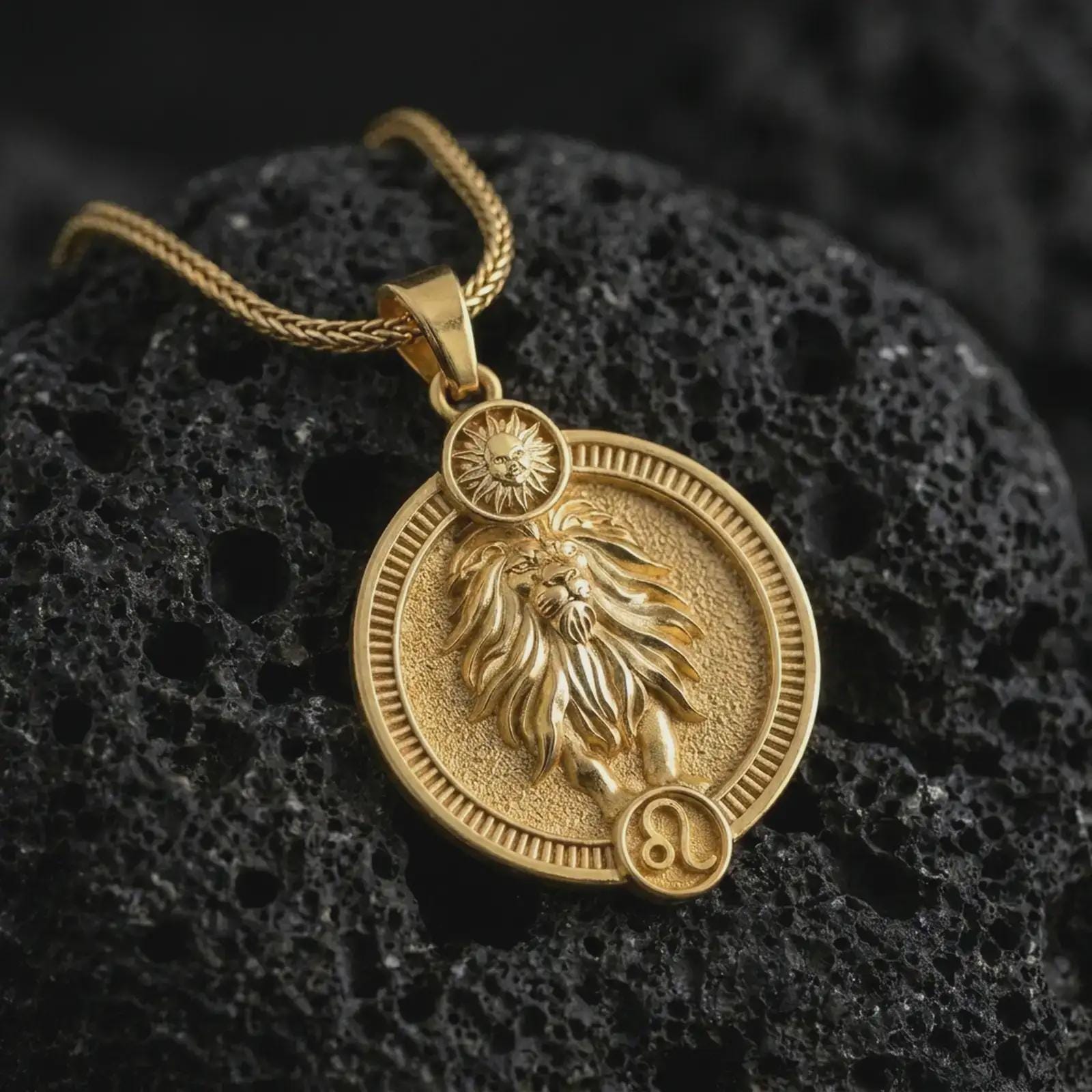Gold plated Leo zodiac pendant necklace on textured volcanic rock, premium close-up studio composition emphasizing the lion figure, flowing mane, and astrology medallion design.