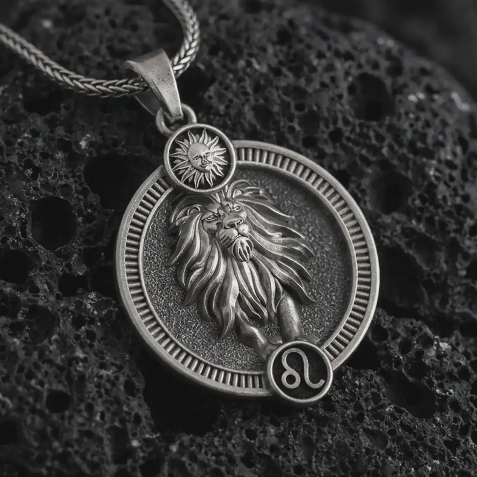 Oxidized Leo zodiac pendant necklace on textured volcanic rock, close-up studio shot highlighting the lion relief, sun detail, Leo symbol, and antique silver contrast.