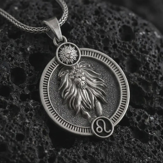 Oxidized Leo zodiac pendant necklace on textured volcanic rock, close-up studio shot highlighting the lion relief, sun detail, Leo symbol, and antique silver contrast.