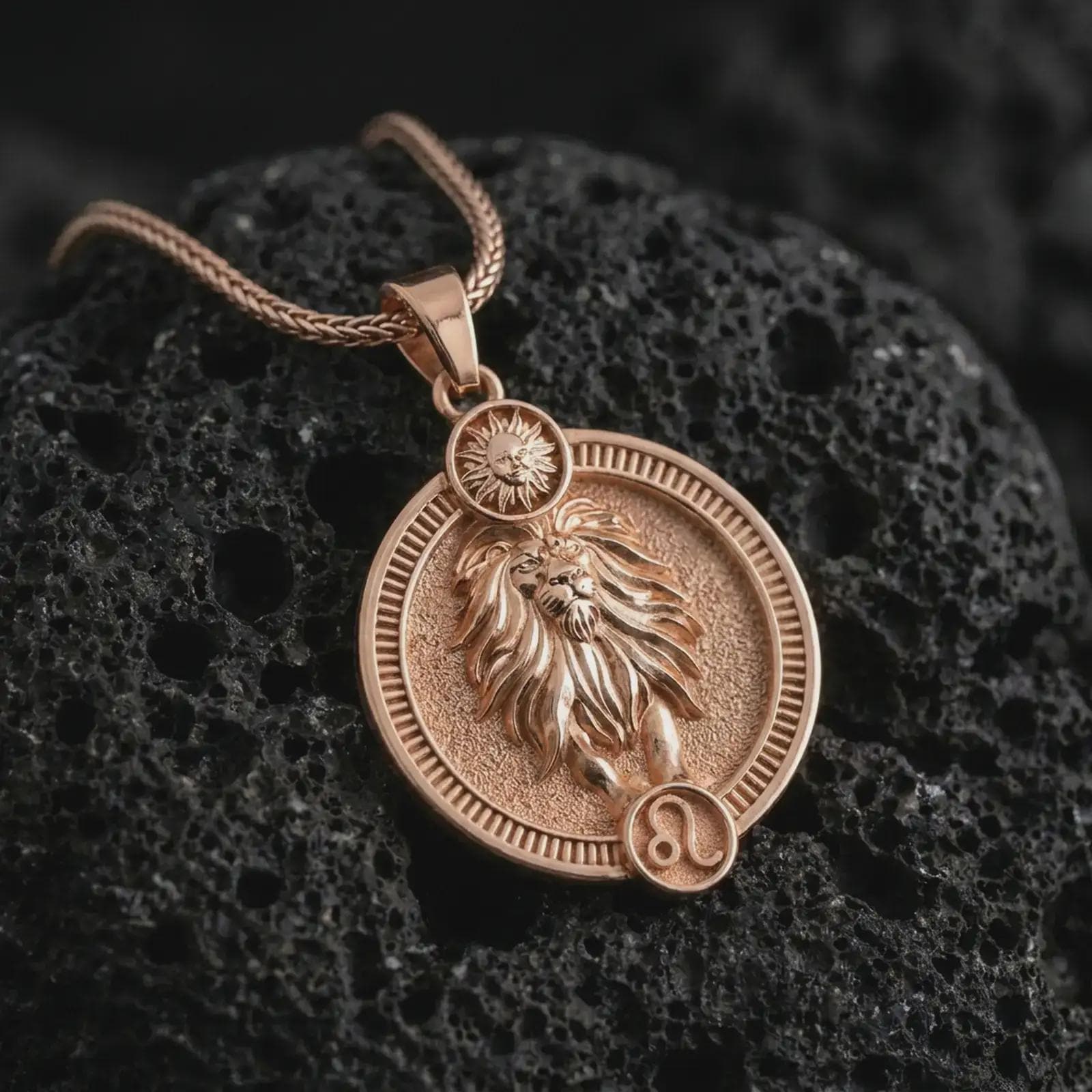 Rose gold plated Leo zodiac pendant necklace on textured volcanic rock, detailed macro product shot with soft warm reflections and symbolic zodiac styling.