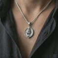 Load image into Gallery viewer, Polished silver Leo zodiac pendant necklace worn on the chest, masculine lifestyle shot highlighting the lion relief, sun detail, and bright silver finish.
