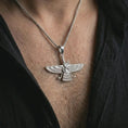 Load image into Gallery viewer, Polished silver Faravahar pendant necklace worn on the chest, masculine lifestyle shot highlighting the bright silver finish, wing details, and Ahura Mazda-inspired design.
