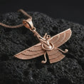 Load image into Gallery viewer, Rose gold plated Faravahar pendant necklace on textured volcanic rock, detailed macro product shot with soft warm reflections and symbolic Zoroastrian styling.
