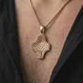 Load image into Gallery viewer, A rose gold plated Tree of Life cross pendant is worn on the neck in a close-up lifestyle composition, highlighting its botanical cross form and Tree of Life meaning.
