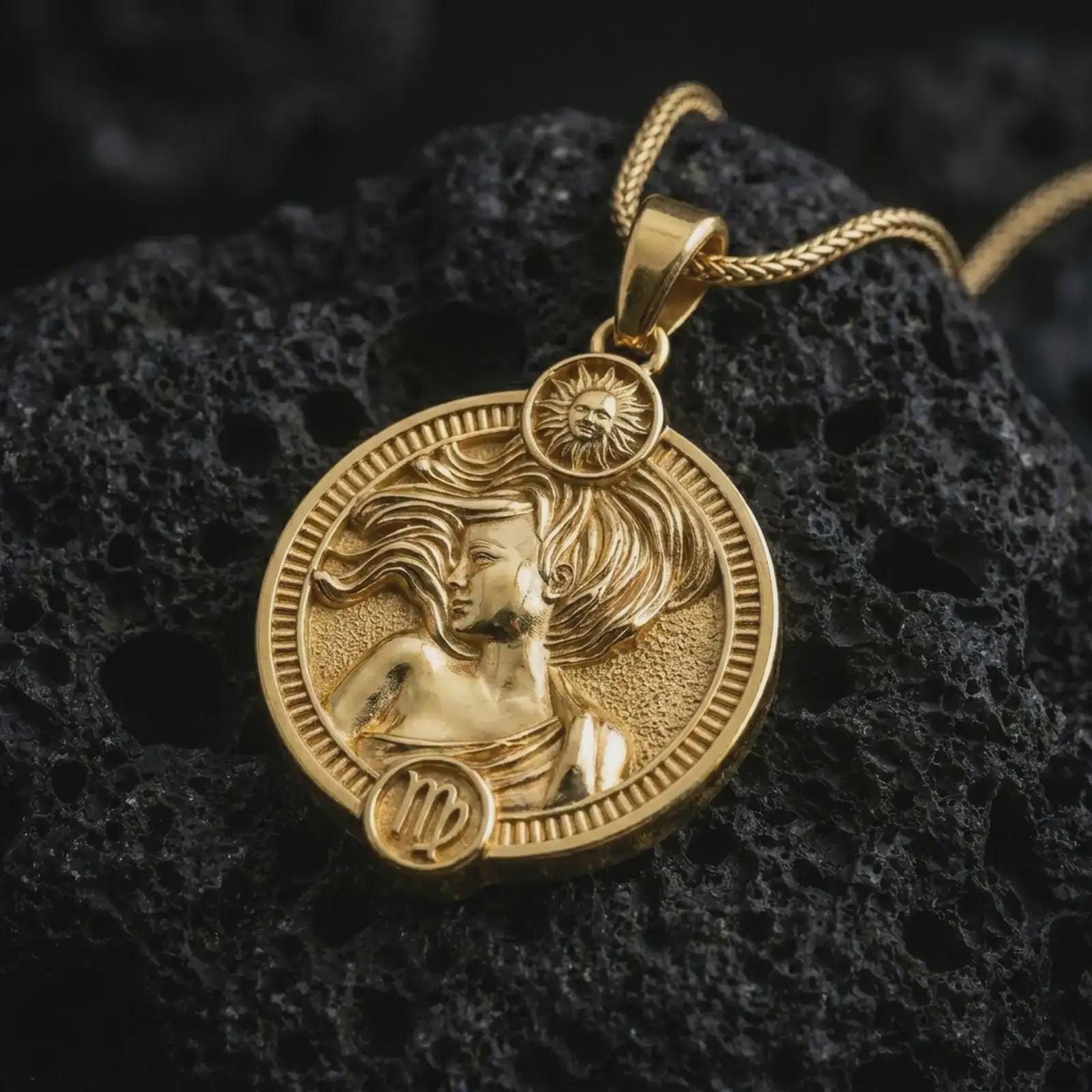 Gold plated Virgo zodiac pendant necklace on textured volcanic rock, premium close-up studio composition emphasizing the graceful woman figure, sun motif, and astrology medallion design.