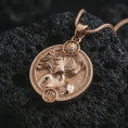 Load image into Gallery viewer, Rose gold plated Virgo zodiac pendant necklace on textured volcanic rock, detailed macro product shot with soft warm reflections and symbolic zodiac styling.
