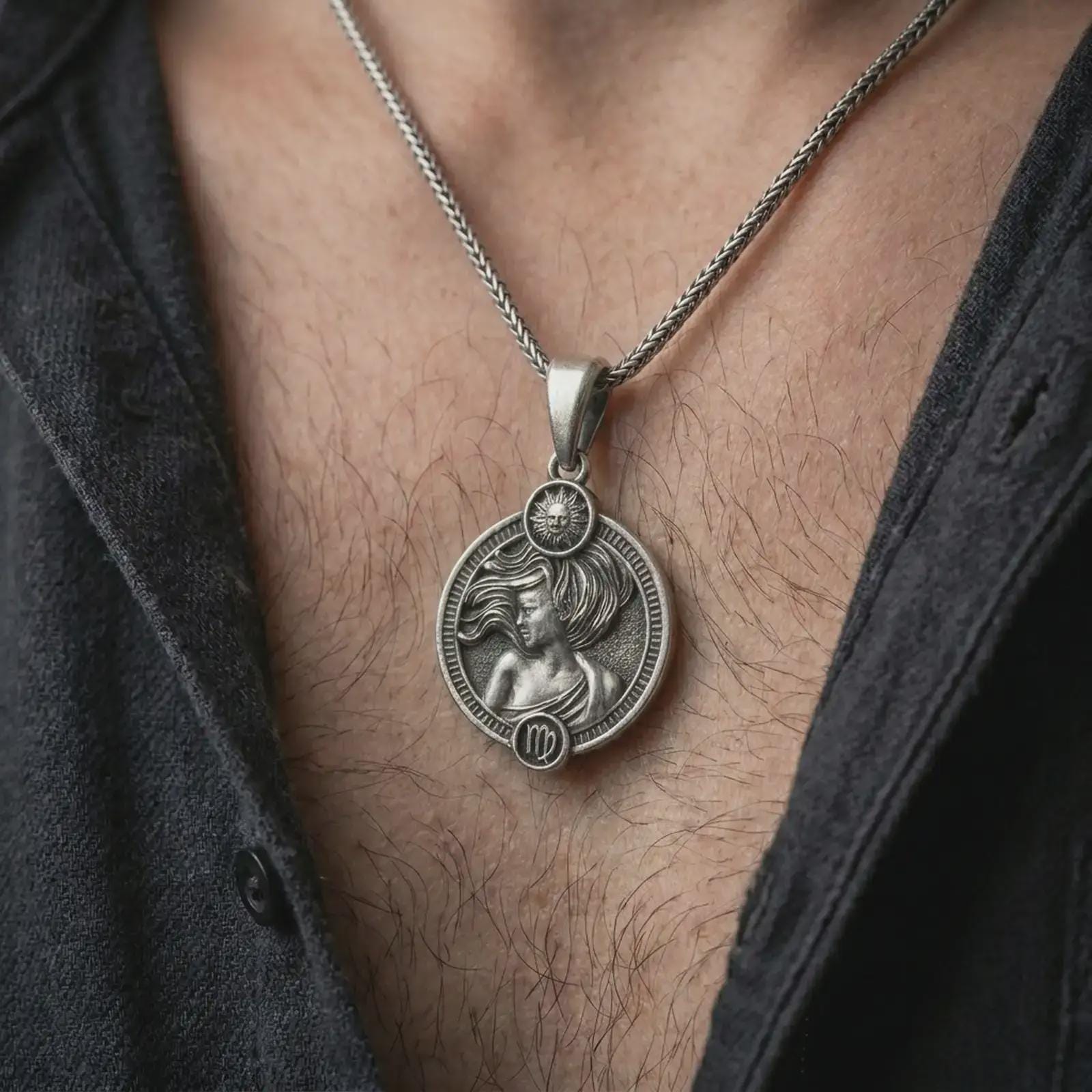 Oxidized Virgo zodiac pendant necklace worn on the chest, close-up lifestyle jewelry photo showing the elegant astrology medallion on a spiga chain with dark clothing.