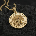 Load image into Gallery viewer, Gold plated Spartan warrior pendant necklace on textured volcanic rock, premium close-up studio composition emphasizing the shield, spear, helmet, and strength family courage inscription.
