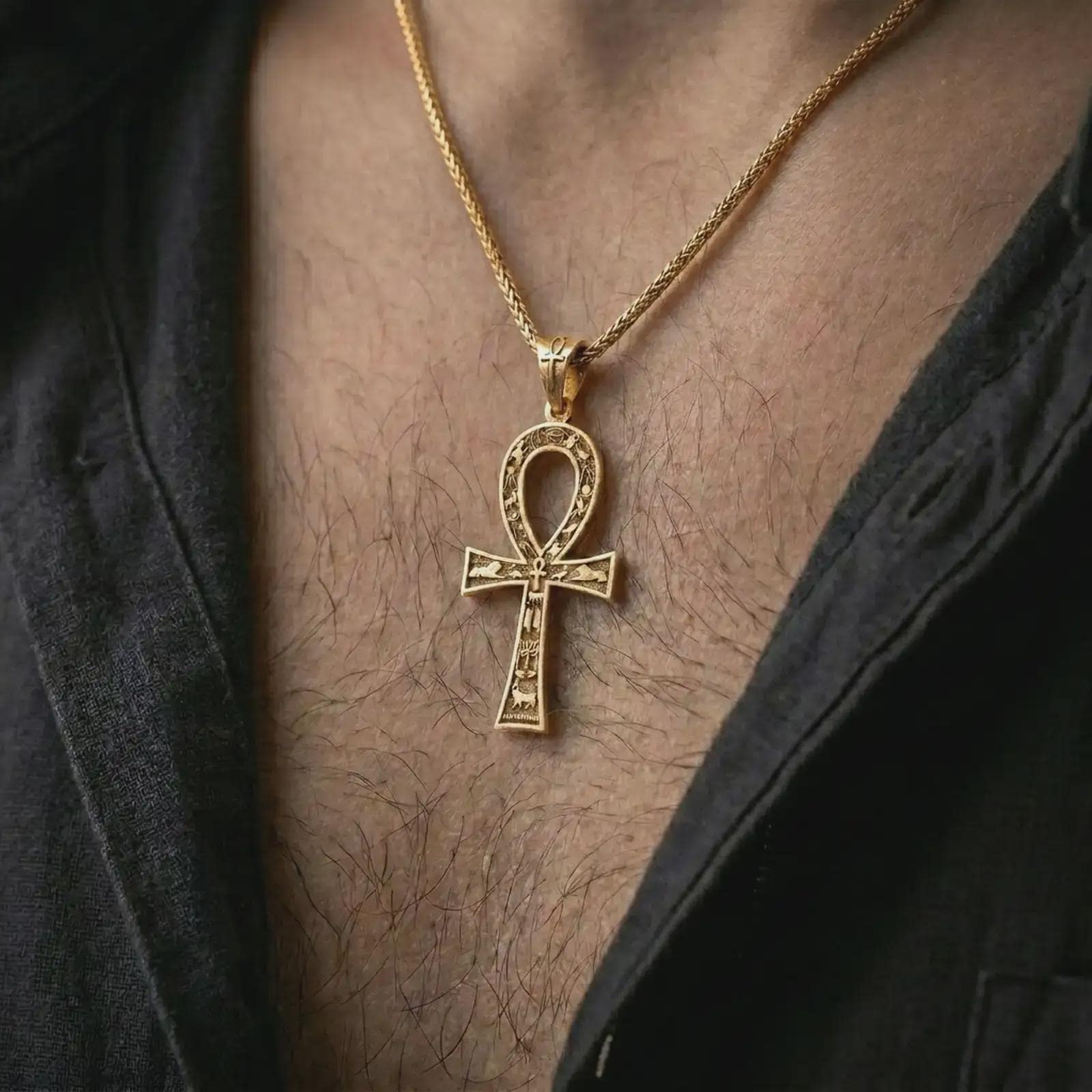 Gold plated ankh cross pendant necklace worn on the chest, premium lifestyle jewelry photo with the Egyptian ankh pendant centered on a spiga chain.