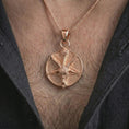 Load image into Gallery viewer, Rose gold plated goat pentagram pendant necklace worn on the chest, close-up lifestyle shot featuring the dark goat pentagram design with warm rose gold tones.
