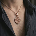 Load image into Gallery viewer, Rose gold plated Aquarius zodiac pendant necklace worn on the chest, close-up lifestyle shot featuring the flowing Aquarius zodiac design with warm rose gold tones.
