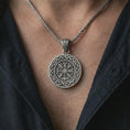 Load image into Gallery viewer, Oxidized Vegvisir Viking compass pendant necklace worn on the chest, close-up lifestyle jewelry photo showing the Norse protection medallion on a spiga chain with dark clothing.
