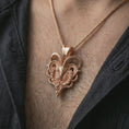 Load image into Gallery viewer, Rose gold plated biomechanical ram skull pendant necklace worn on the chest, close-up lifestyle shot featuring the gothic ram skull design with warm rose gold tones.

