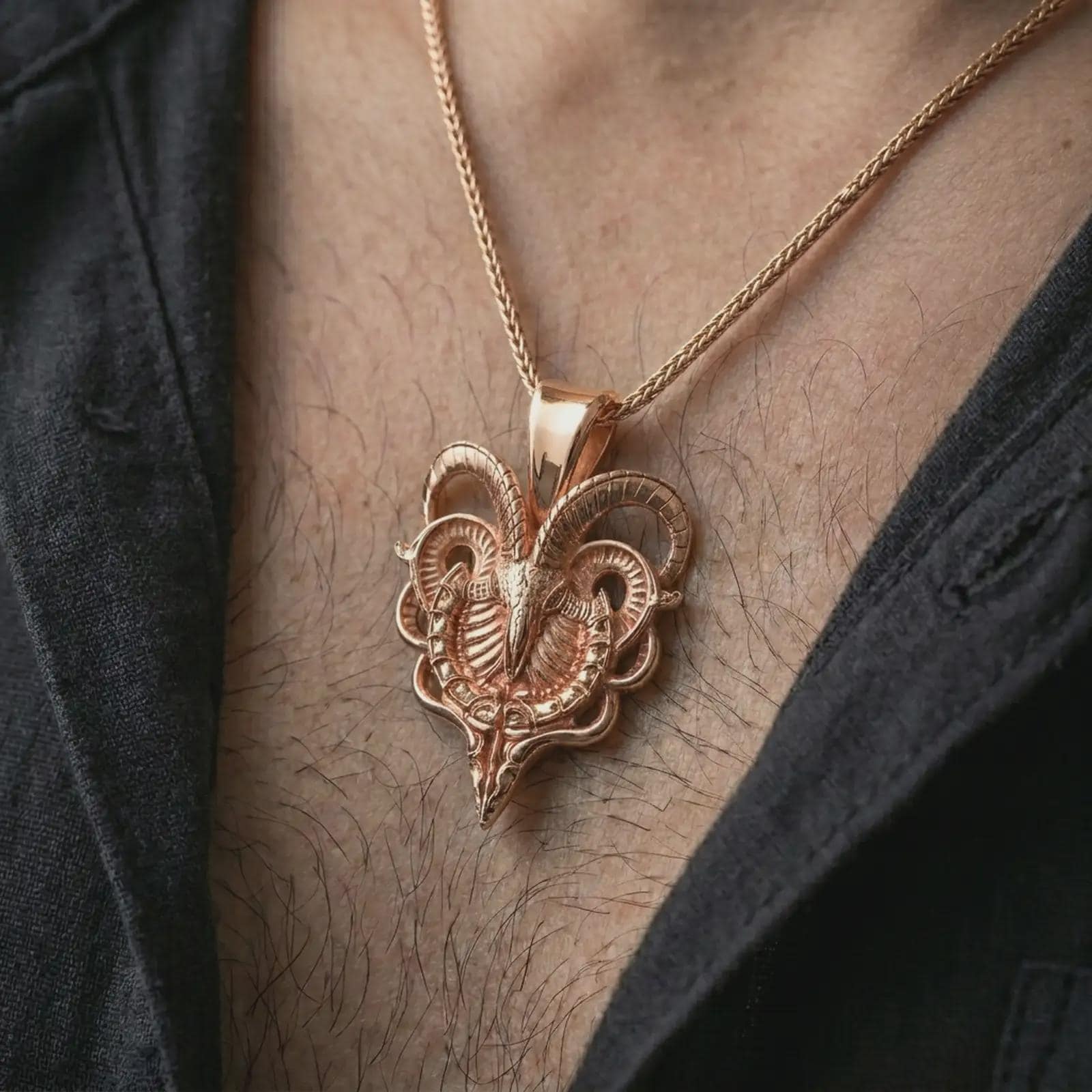 Rose gold plated biomechanical ram skull pendant necklace worn on the chest, close-up lifestyle shot featuring the gothic ram skull design with warm rose gold tones.