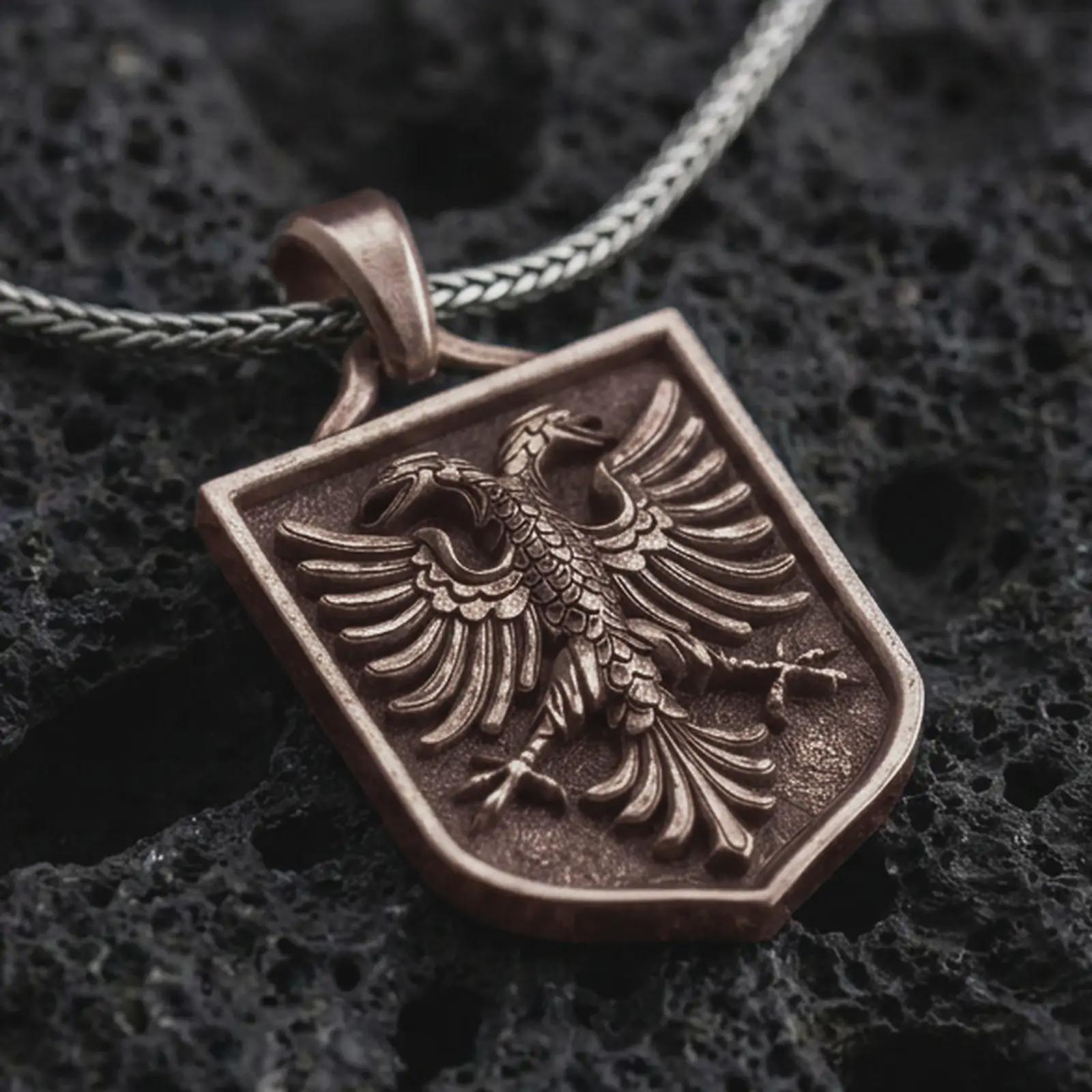 Bronze double-headed eagle shield pendant necklace on textured volcanic rock, close-up studio shot highlighting the twin eagle heads, spread wings, crest frame, and antique silver contrast.