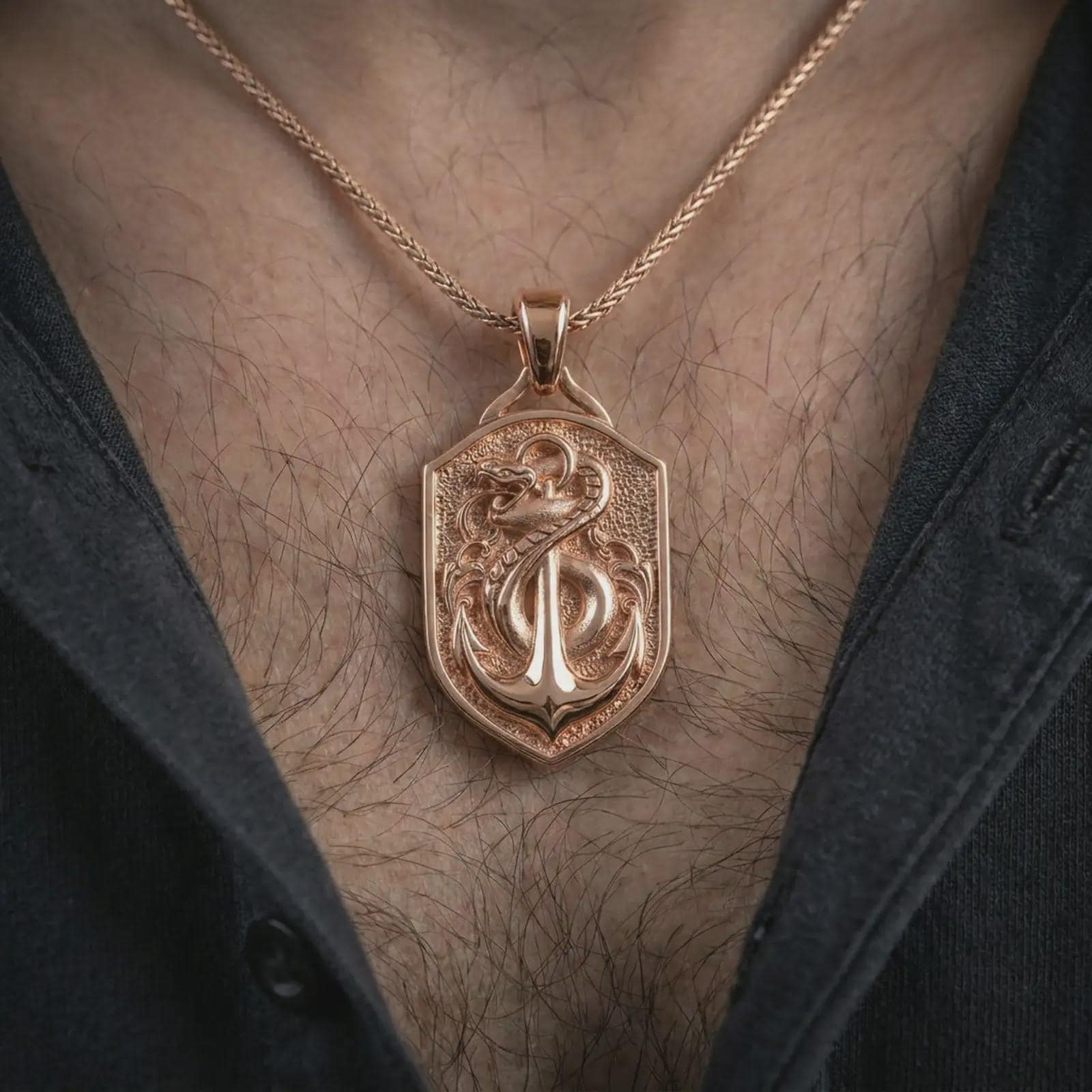Rose gold plated serpent and anchor pendant necklace worn on the chest, close-up lifestyle shot featuring the serpent and anchor design with warm rose gold tones.