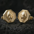 Load image into Gallery viewer, Gold plated gorilla cufflinks on textured volcanic rock, premium close-up studio composition emphasizing the bold ape expression, sharp octagonal shape, and statement menswear design.
