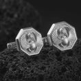 Load image into Gallery viewer, Polished silver scarab cufflinks are displayed on black volcanic rock in a premium macro studio close-up with detailed wings, beetle body, and Eye of Horus accent.
