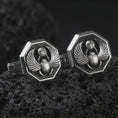Load image into Gallery viewer, An oxidized scarab cufflink pair rests on dark volcanic rock in a macro studio close-up, showing winged beetle details and ancient Egyptian symbolism.
