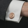 Load image into Gallery viewer, Rose gold plated Saint Michael cufflinks worn on a suit cuff, close-up lifestyle shot featuring the sacred archangel design with warm rose gold tones.
