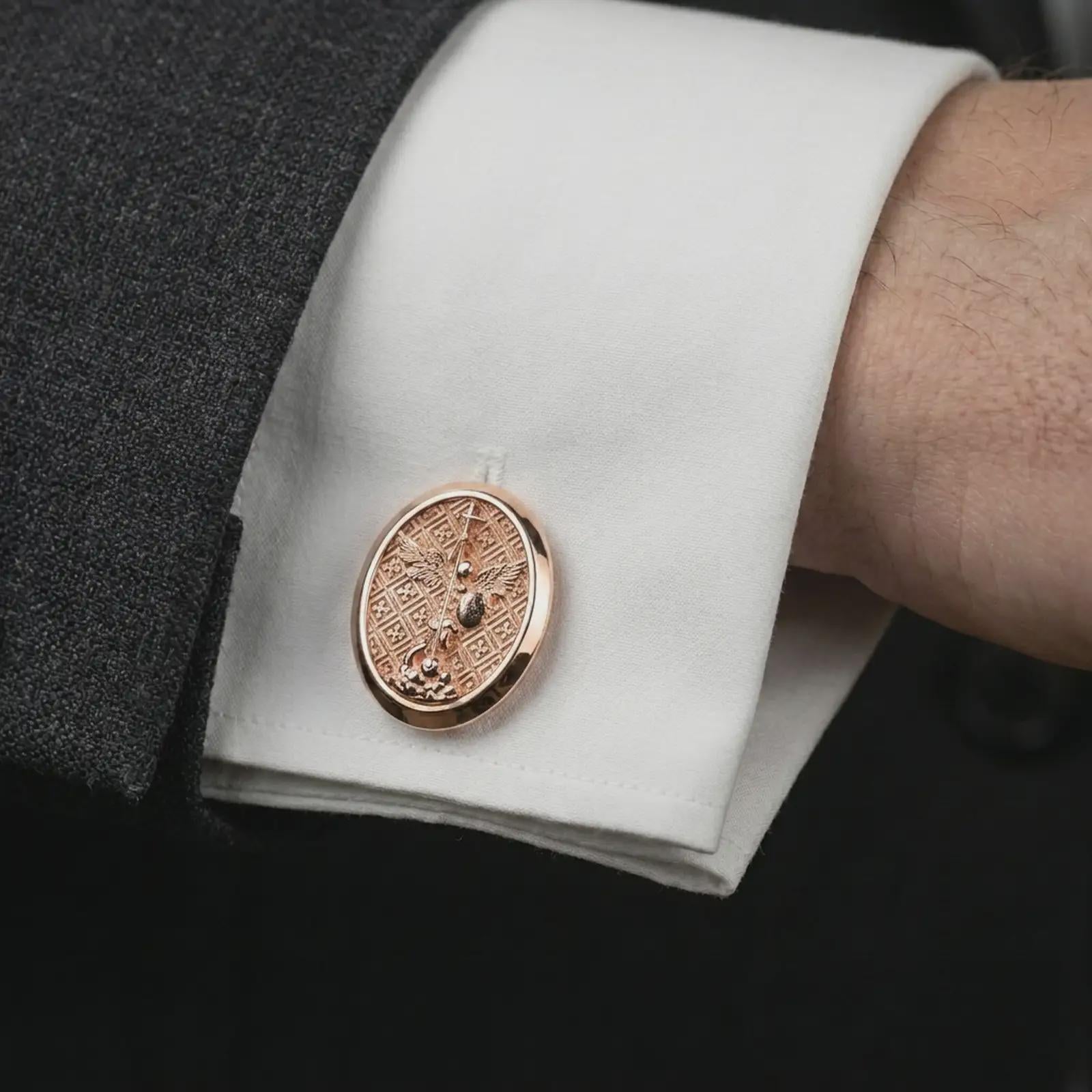 Rose gold plated Saint Michael cufflinks worn on a suit cuff, close-up lifestyle shot featuring the sacred archangel design with warm rose gold tones.