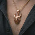 Load image into Gallery viewer, A rose gold plated Loki pendant is worn on the neck in a close-up lifestyle composition, highlighting its angular Loki mask design and dark fantasy character.
