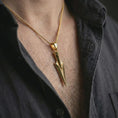 Load image into Gallery viewer, A gold plated Gungnir pendant is worn on the neck in a close-up lifestyle shot, styled as a powerful Viking mythology gift for men.
