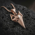 Load image into Gallery viewer, A rose gold plated Freyja cat pendant is photographed on porous volcanic rock in a close-up studio composition with refined luxury lighting and angular sculptural detail.
