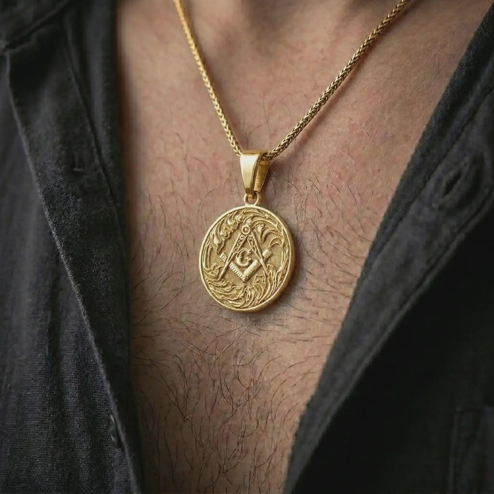 Gold plated Masonic square and compass pendant necklace worn on the chest, premium lifestyle jewelry photo with the Freemason pendant centered on a spiga chain.