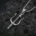 Load image into Gallery viewer, Polished silver Poseidon trident pendant necklace on textured volcanic rock, centered macro jewelry photo with detailed sea god weapon design and bright silver highlights.
