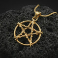 Load image into Gallery viewer, Gold plated thorn pentagram pendant necklace on textured volcanic rock, premium close-up studio composition emphasizing the gothic star symbol, thorn frame, and openwork design.
