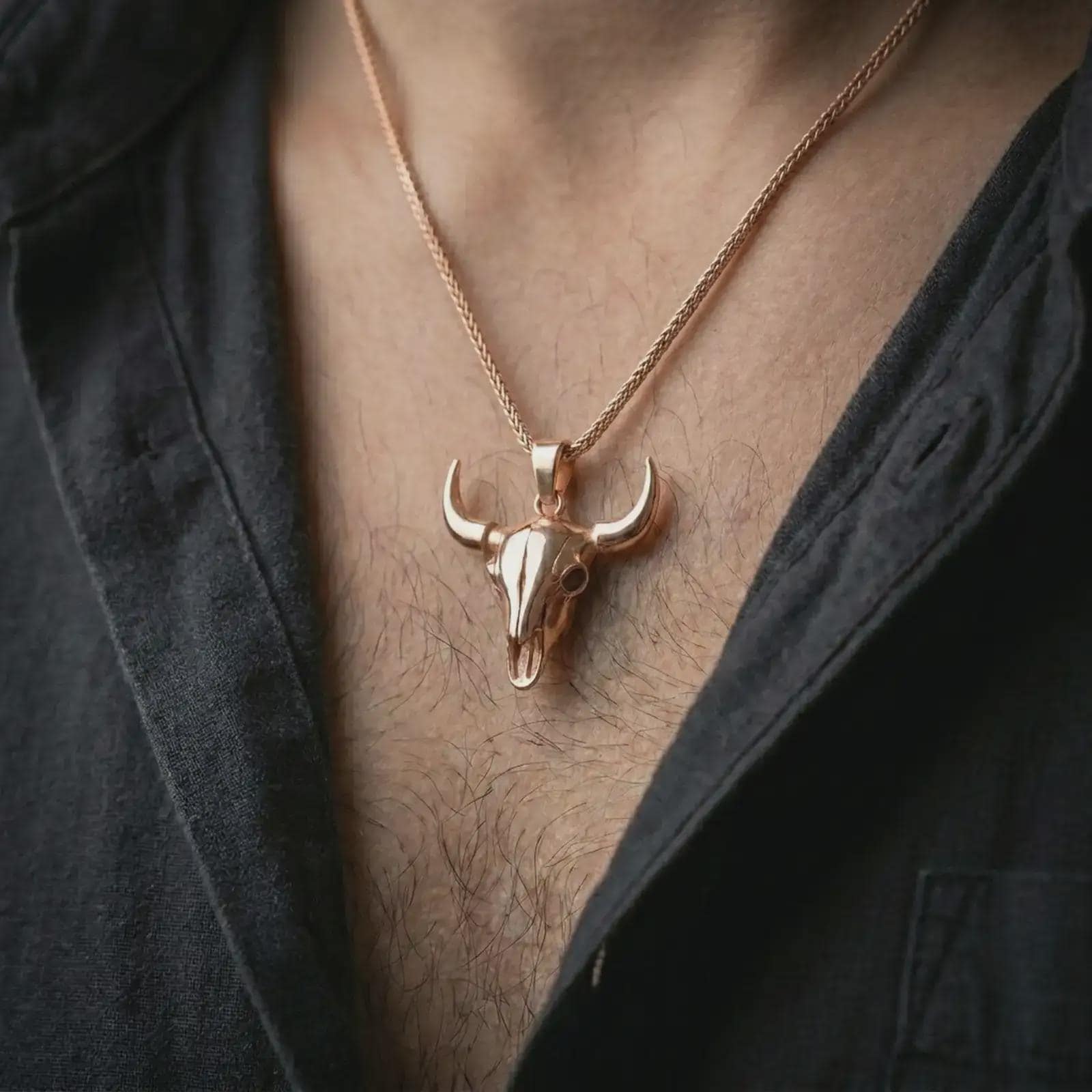 Rose gold plated bull skull pendant necklace worn on the chest, close-up lifestyle shot featuring the rugged bull skull design with warm rose gold tones.