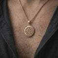 Load image into Gallery viewer, Rose gold plated Vegvisir Viking rune pendant necklace worn on the chest, close-up lifestyle shot featuring the Vegvisir rune design with warm rose gold tones.
