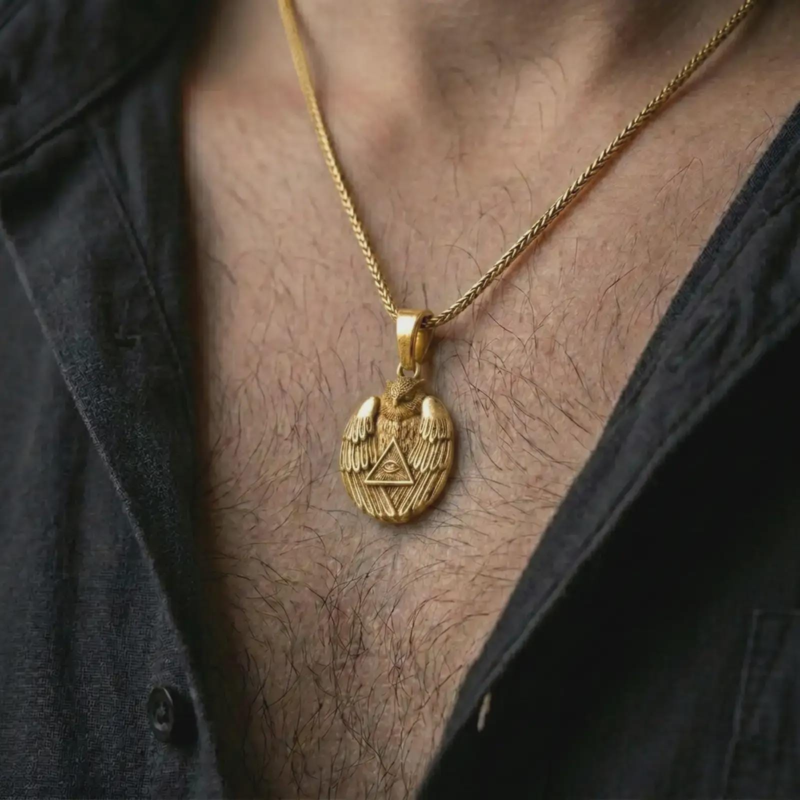 Gold plated owl all-seeing eye pendant necklace worn on the chest, premium lifestyle jewelry photo with the owl talisman pendant centered on a spiga chain.