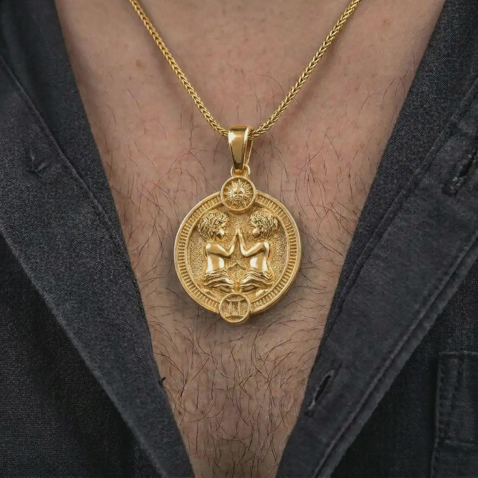 Gold plated Gemini zodiac pendant necklace worn on the chest, premium lifestyle jewelry photo with the Gemini twins pendant centered on a spiga chain.