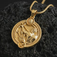 Load image into Gallery viewer, Gold plated Sagittarius zodiac pendant necklace on textured volcanic rock, premium close-up studio composition emphasizing the archer figure, arrow details, and astrology medallion design.
