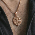 Load image into Gallery viewer, Rose gold plated Sagittarius zodiac pendant necklace worn on the chest, close-up lifestyle shot featuring the adventurous Sagittarius zodiac design with warm rose gold tones.
