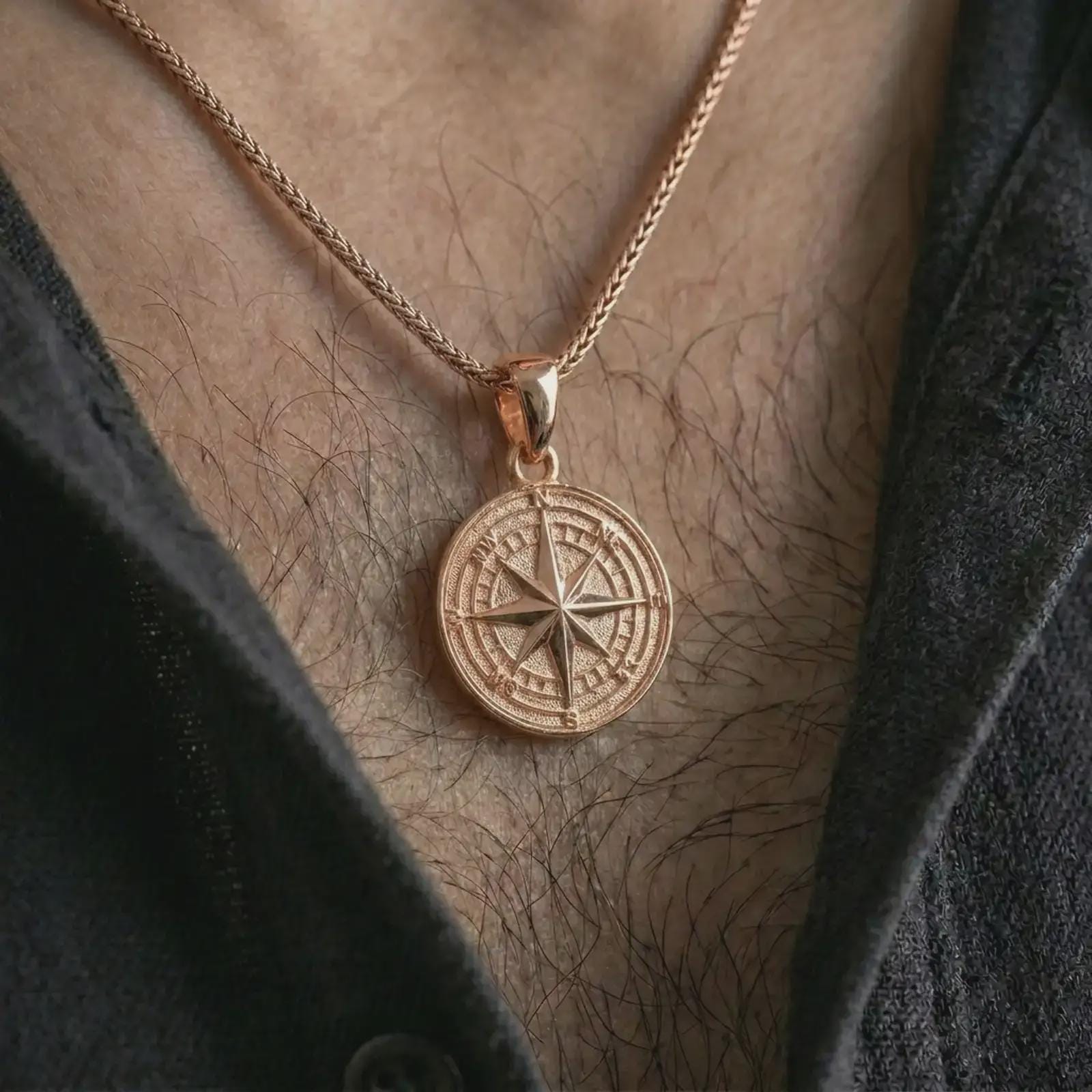 Rose gold plated compass rose pendant necklace worn on the chest, close-up lifestyle shot featuring the explorer compass design with warm rose gold tones.