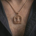 Load image into Gallery viewer, Rose gold plated Vitruvian Man pendant necklace worn on the chest, close-up lifestyle shot featuring the artistic Vitruvian Man design with warm rose gold tones.

