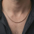 Load image into Gallery viewer, A rose gold plated foxtail chain necklace is worn on the neck in a close-up lifestyle composition, highlighting its Italian wheat weave and clean masculine look.
