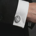 Load image into Gallery viewer, A polished silver Blessed Mother cufflink is worn on a shirt cuff in a premium close-up lifestyle image, showing the Virgin Mary and Child relief clearly.
