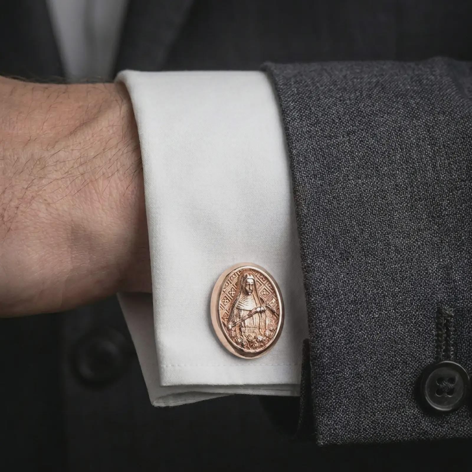 A rose gold plated Mary Magdalene cufflink is worn on a shirt cuff in a close-up lifestyle composition, highlighting its oval frame and Saint Mary Magdalene design.