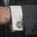 Load image into Gallery viewer, An oxidized Mary Magdalene cufflink is worn on a white shirt cuff in a close-up lifestyle shot, styled with a dark suit as a meaningful Christian accessory.

